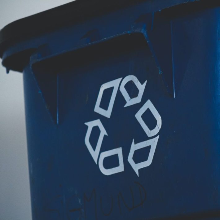 Blue recycling bin with recycling logo